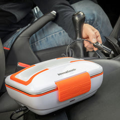 Pro Bentau Lunchbox auf dem Beifahrersitz neben eingestecktem 12-V-Autokabel