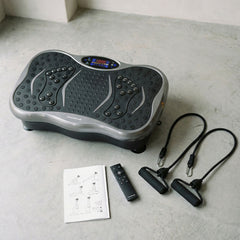 Vivflow-Vibrationsplatte mit Fernbedienung, Widerstandsbändern und Übungsanleitung auf einem Boden